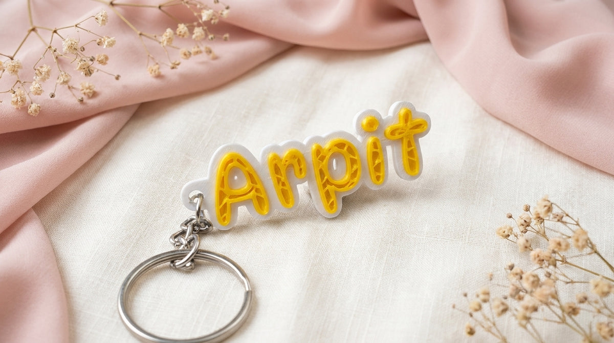 Angled front view of Yellow NameLoop personalized name keychain and included keyring