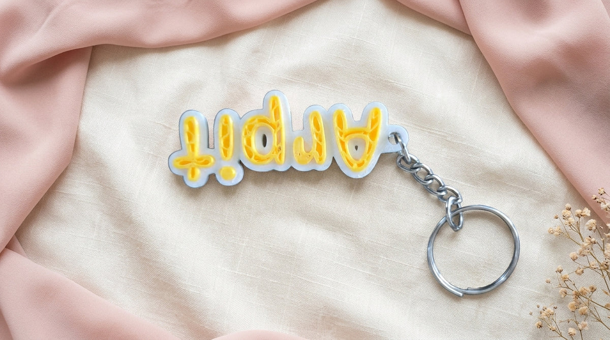Inverted front view of Yellow NameLoop personalized name keychain with included keyring